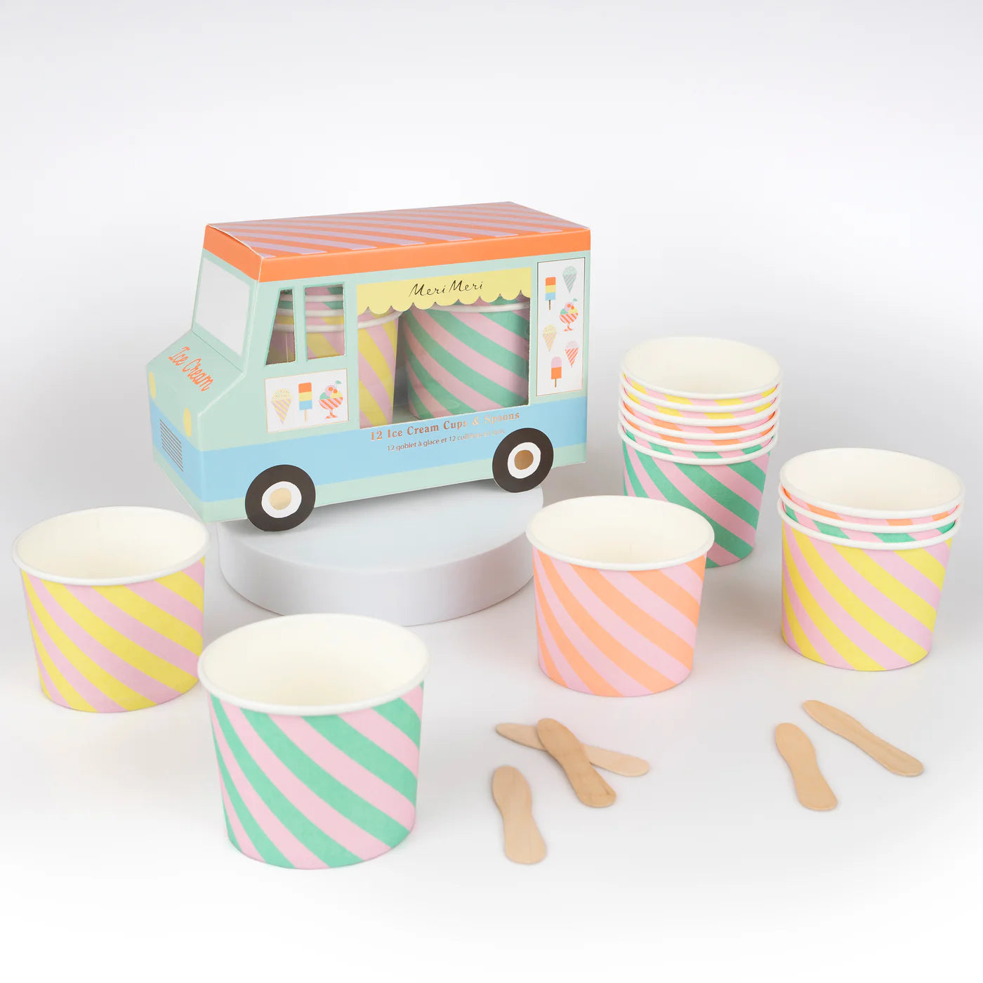A colorful pastel ice cream truck box with 12 ice cream cups and spoons inside surrounded by more ice cream cups and spoons.
