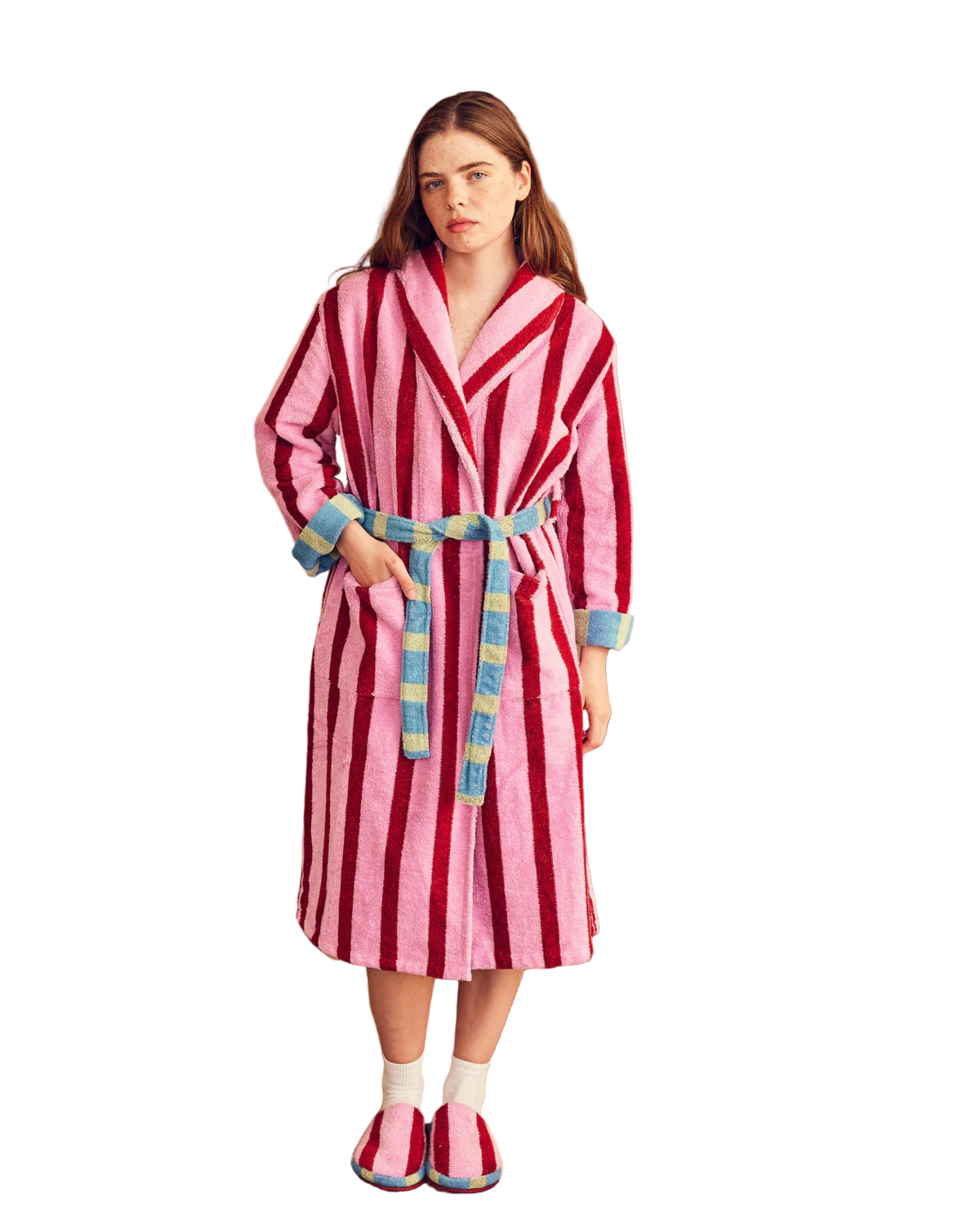 Woman wearing a pink and red striped robe with colorful trim.