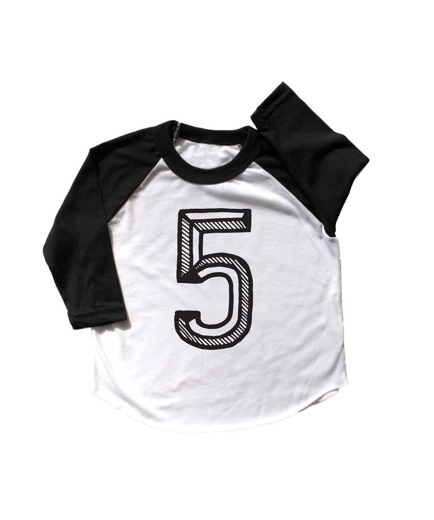 Baseball tee white with black sleeves screen printed with black number 5.