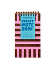 Pocket notebook with striped cover and blue label on a beige background