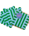 Packaged green and blue coasters on a beige background