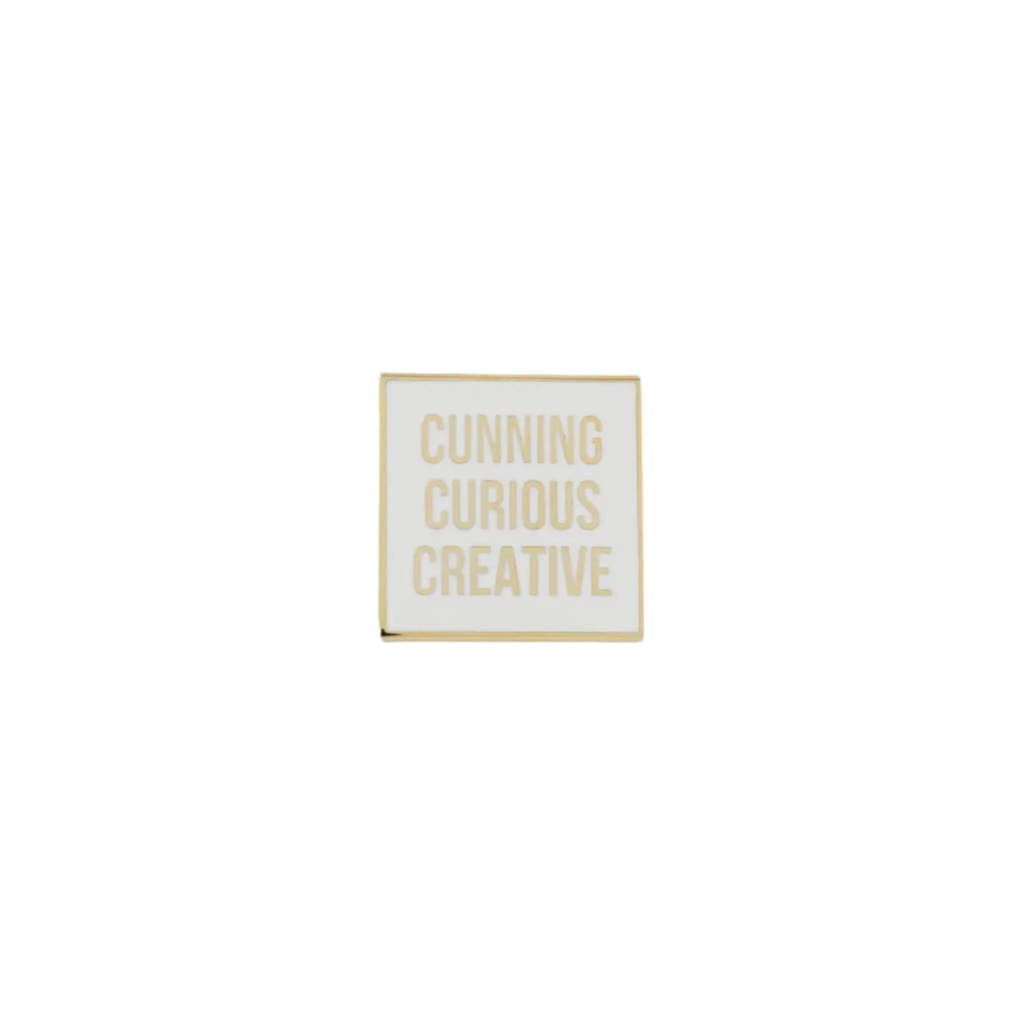 A gold-plated square pin with the text 'Cunning Curious Creative' on it, displayed against a white background.