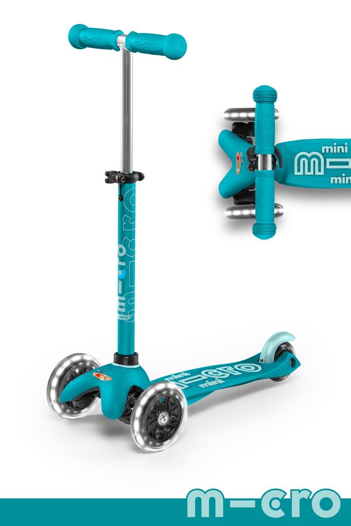 A teal and light teal three wheeled push scooter with the front two wheels lit up with LED lights.