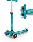 A teal and light teal three wheeled push scooter with the front two wheels lit up with LED lights.