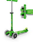 A Green and light Green three wheeled push scooter with the front two wheels lit up with LED lights.