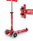 A red and white three wheeled push scooter with the front two wheels lit up with LED lights.